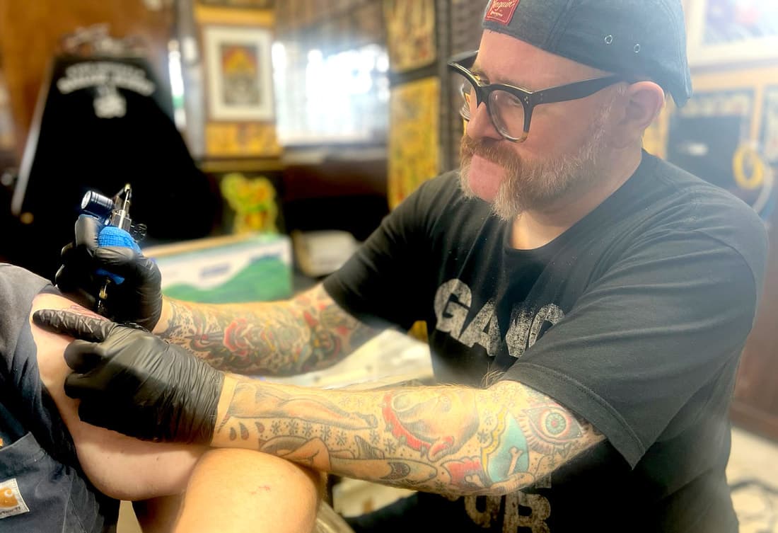 Mad Max Wallace, from Top hat Tattoo and Top Hat Barber Shop’s website