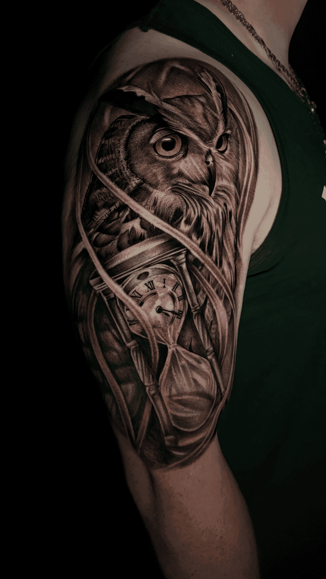 Black-and-grey half sleeve with an owl and a clock